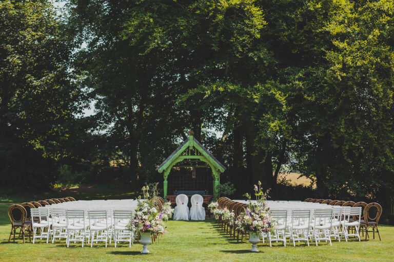 Ceremony chairs set out beside a floral arch, Ballinacurra House