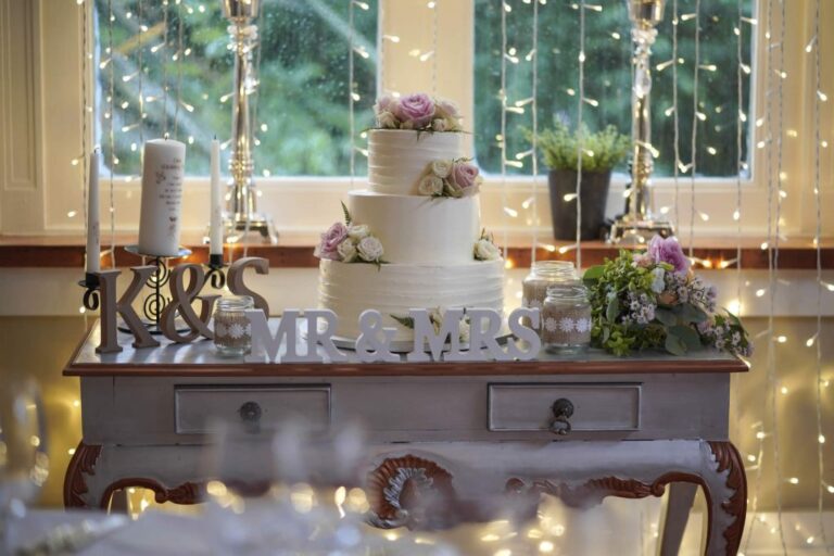 A wedding cake table lit with fairy lights, Ballinacurra House