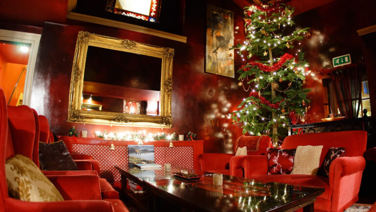 A red drawing room dressed for Christmas, Ballinacurra House