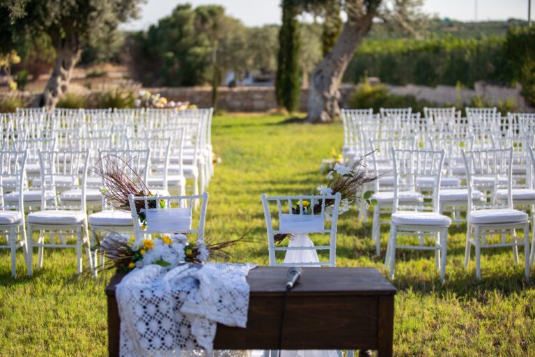 Chairs and signing table set for an outdoor ceremony among olive trees, Ballium Luxury Relais