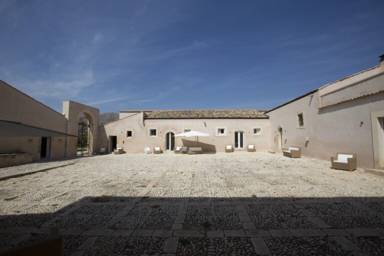 Courtyard and low buildings of the historic baglio, Ballium Luxury Relais