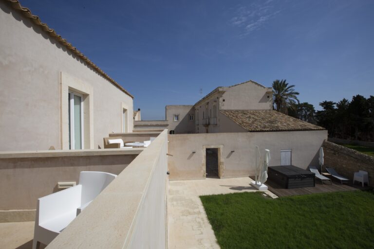 Rooftops and terrace with sun loungers seen from above, Ballium Luxury Relais