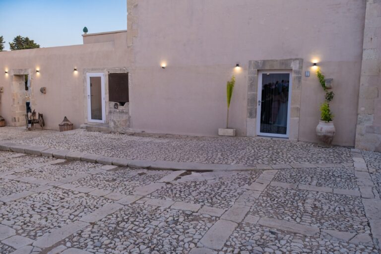 Courtyard entrance doors lit at dusk, Ballium Luxury Relais