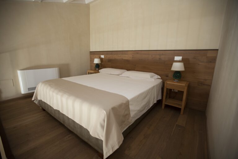 Double bedroom with timber headboard, Ballium Luxury Relais