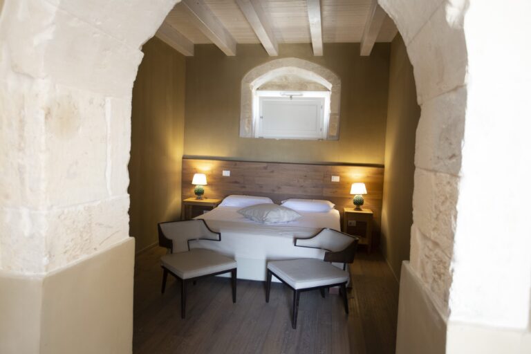 Bedroom set within a stone arch, Ballium Luxury Relais