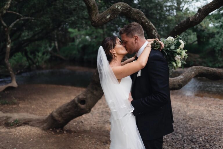 A couple kissing beneath a low, twisting tree beside a forest stream, Balmer Lawn Hotel & Spa