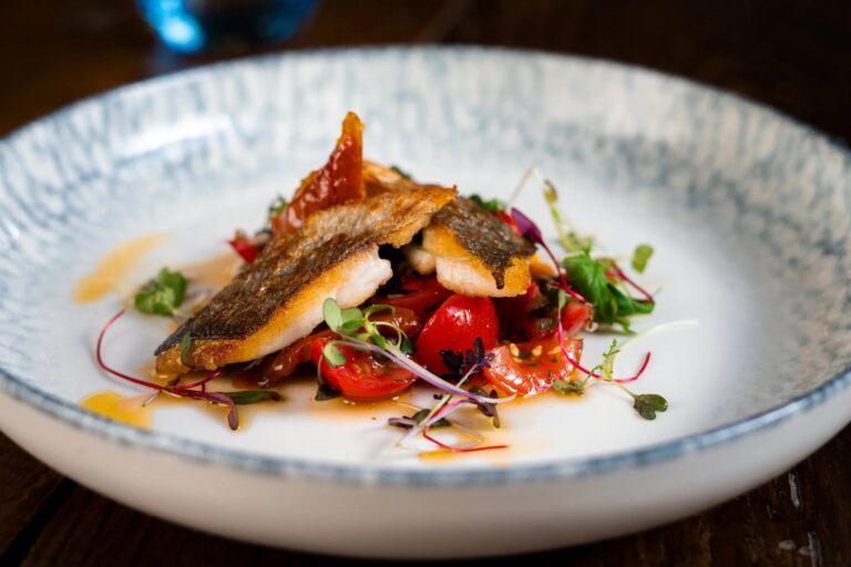 Pan-fried sea bass on tomatoes and micro herbs, served in a glazed bowl, Balmer Lawn Hotel & Spa