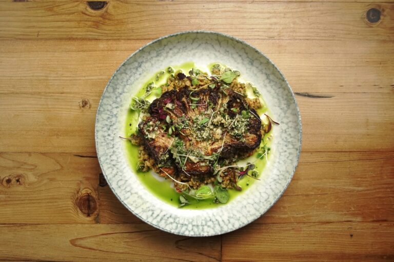 Roasted za'atar cauliflower steak on grains with green herb oil, seen from above, Balmer Lawn Hotel & Spa