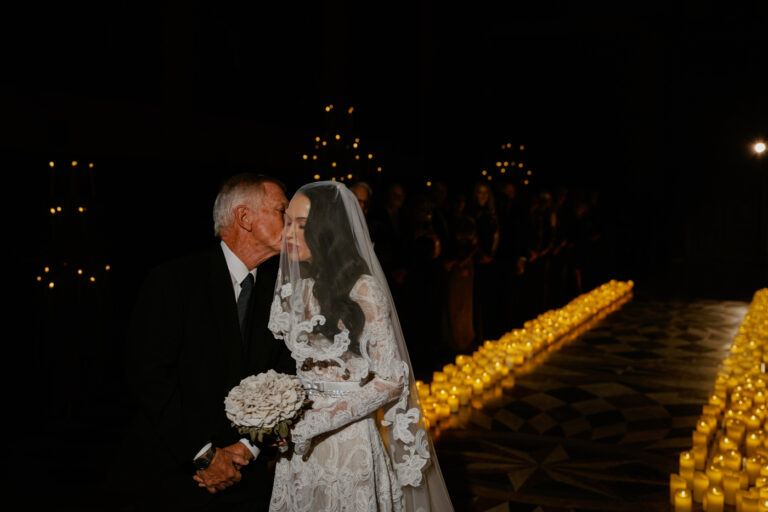 The bride arriving between rows of candles, Scuola Grande di San Giovanni Evangelista, Venice, Barbara Zanon Photography