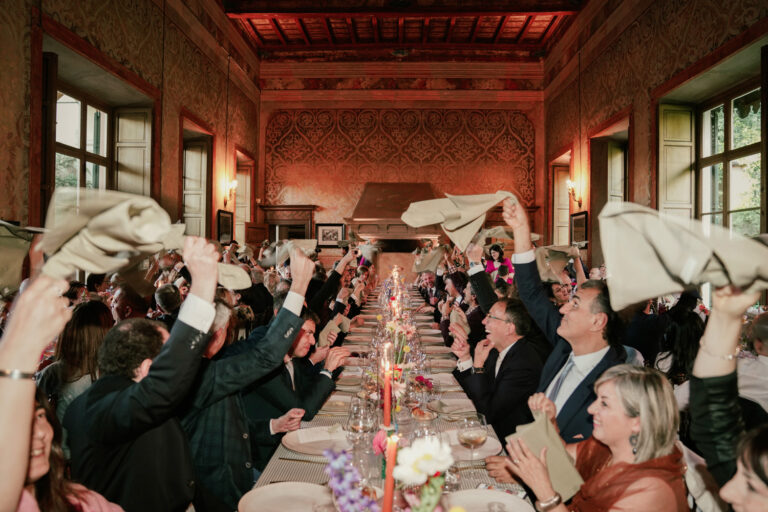 Guests waving napkins above their heads at dinner, Villa Semenza, Lecco, Barbara Zanon Photography