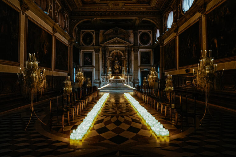 A candlelit aisle laid for the ceremony at the Scuola Grande di San Giovanni Evangelista, Venice, Barbara Zanon Photography