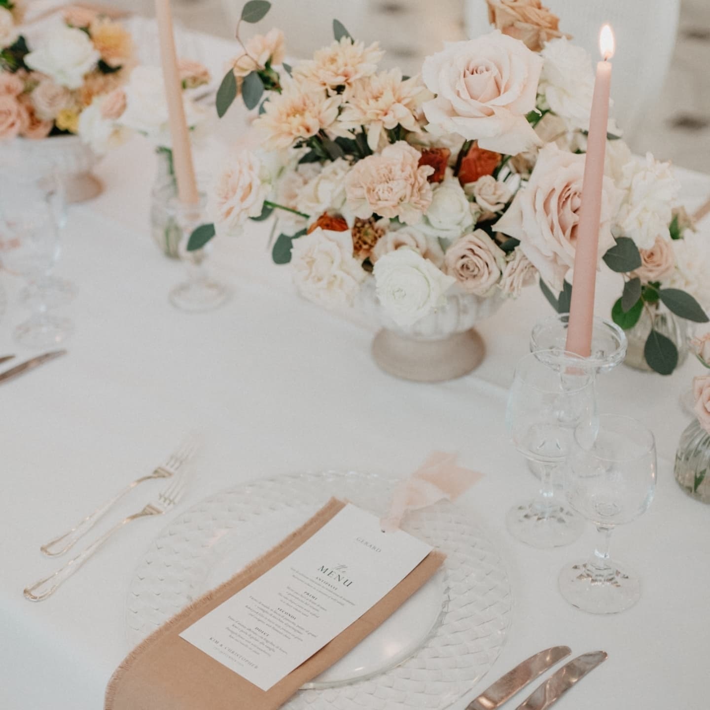 A table set with peach flowers and candles, Bella Sposa, Wedding & Event Planning in Italy