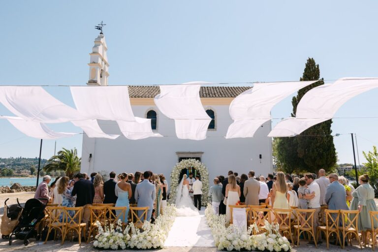 A wedding ceremony beneath white canopies beside the sea in Corfu, Belli Momenti