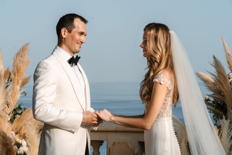 A couple exchange vows before pampas grass and the sea at Villa Sylva, Corfu, Belli Momenti