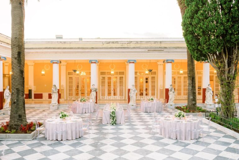 Reception tables laid on a chequered patio for a Catholic wedding in Corfu, Belli Momenti