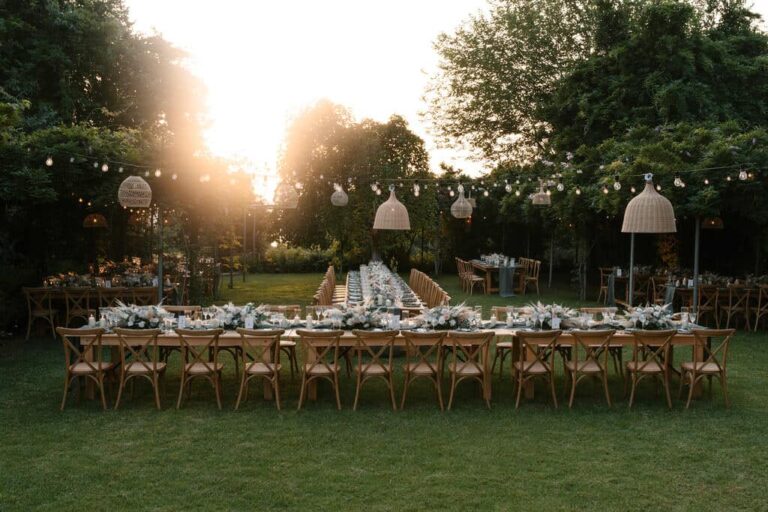 A long reception table on the lawn at sunset at Villa Sylva, Corfu, Belli Momenti