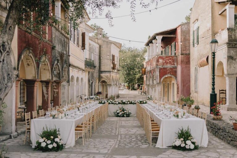 Reception tables laid along a village street at Danilia Village, Corfu, Belli Momenti