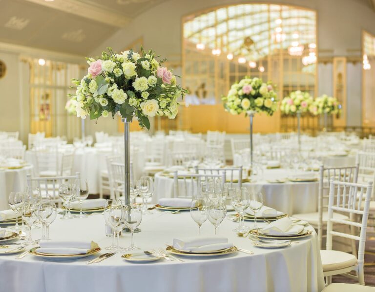 Banquet tables set with white linen and white flowers, Belmond Grand Hotel Europe