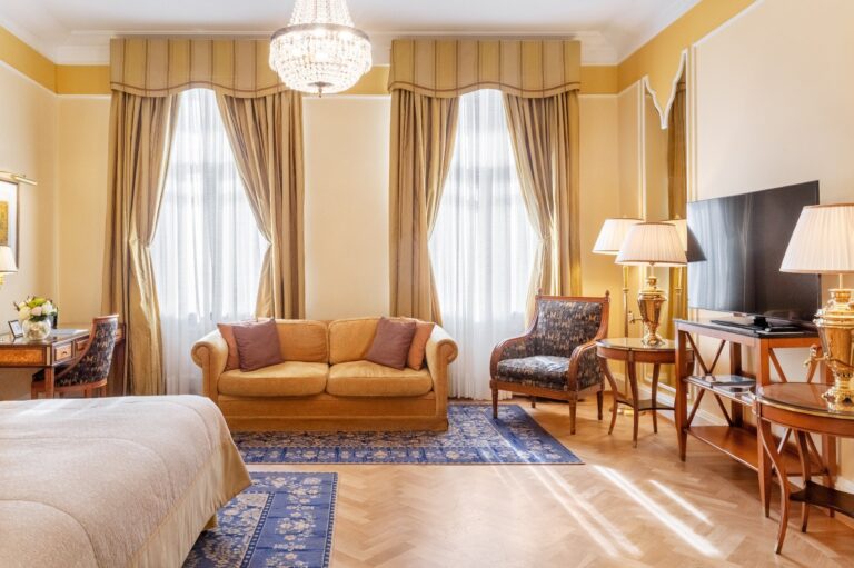 A Junior Suite bedroom and sitting area, Belmond Grand Hotel Europe