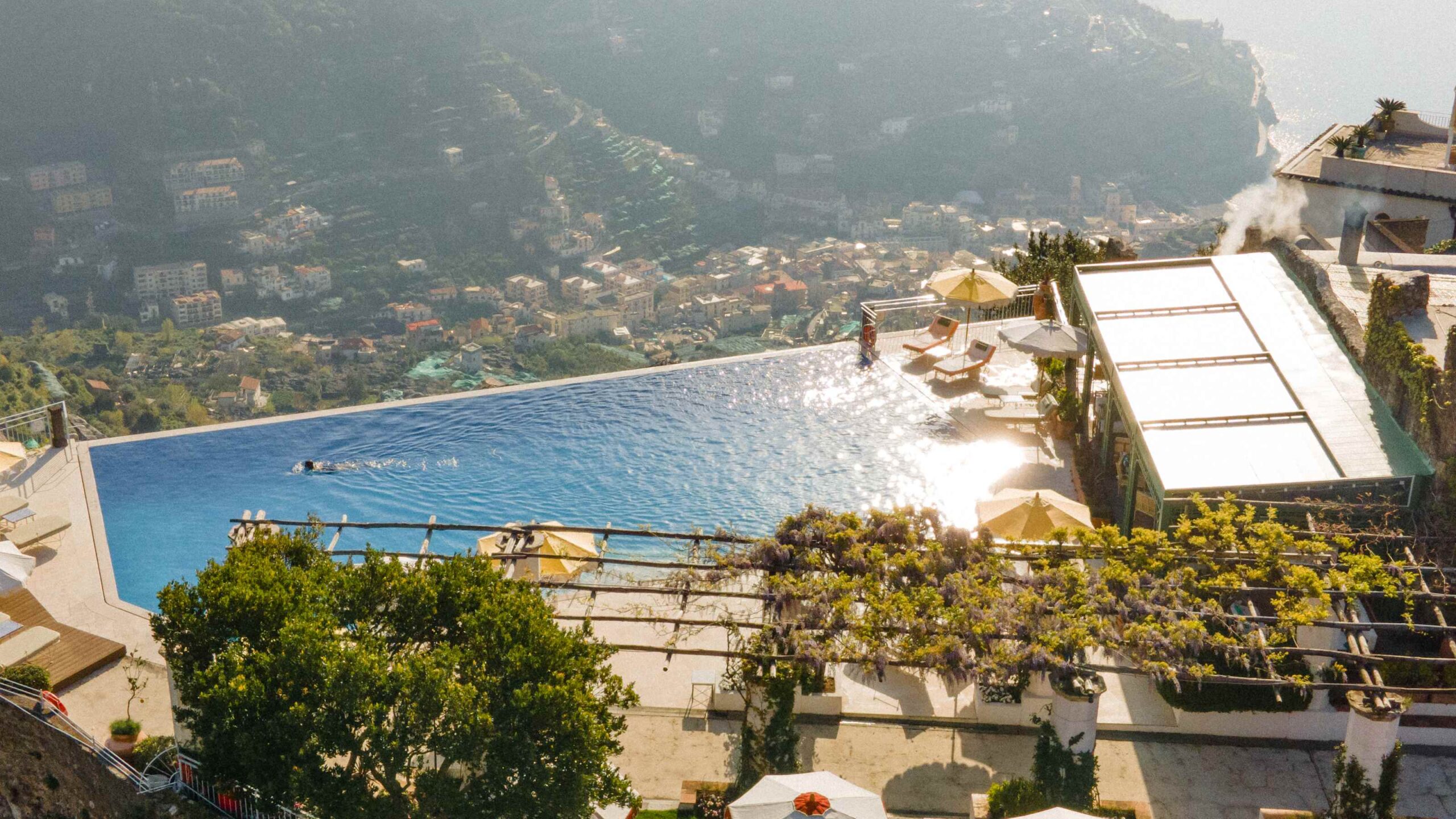 Infinity pool terrace and the hotel on the hillside above the Amalfi Coast, Belmond Hotel Caruso