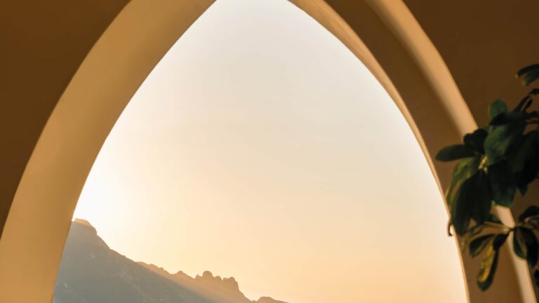 Pointed arch framing the coastal view at sunset, Belmond Hotel Caruso