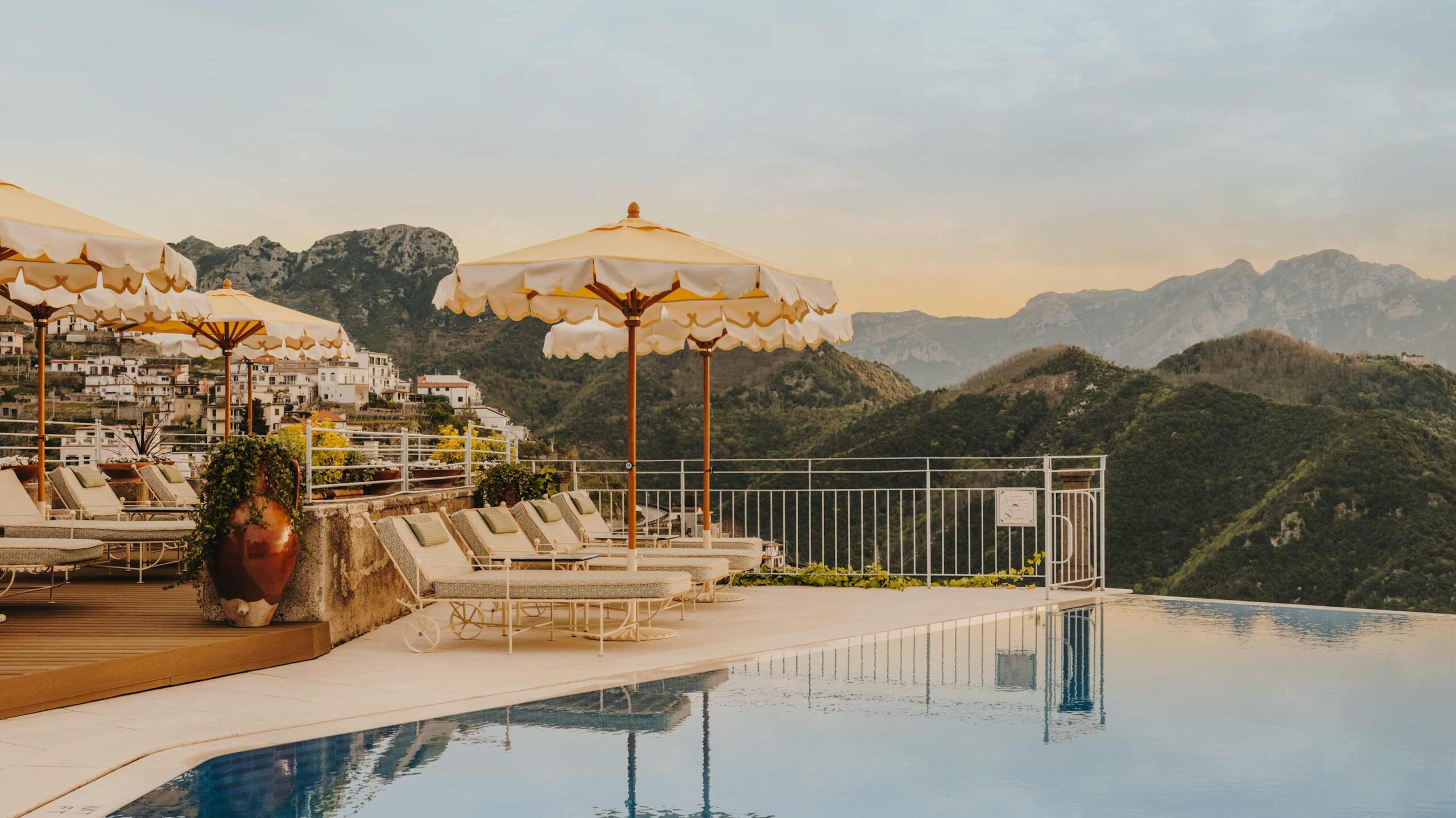 Pool terrace with sun loungers and parasols, Belmond Hotel Caruso