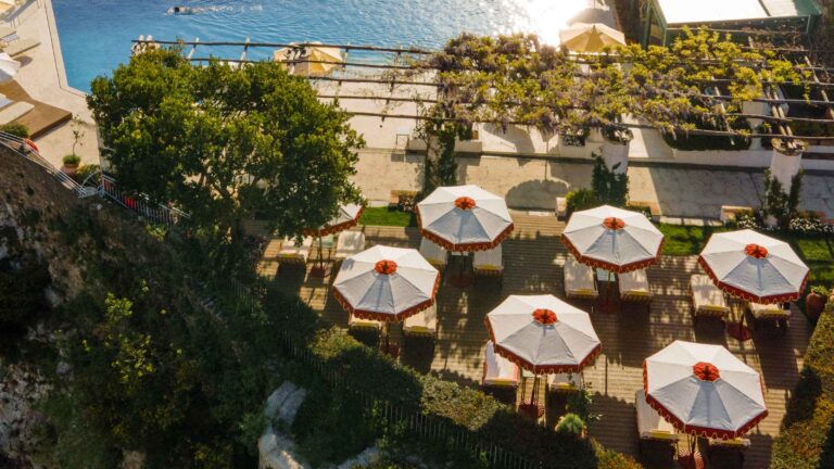 Garden terrace below the pool with parasols, Belmond Hotel Caruso