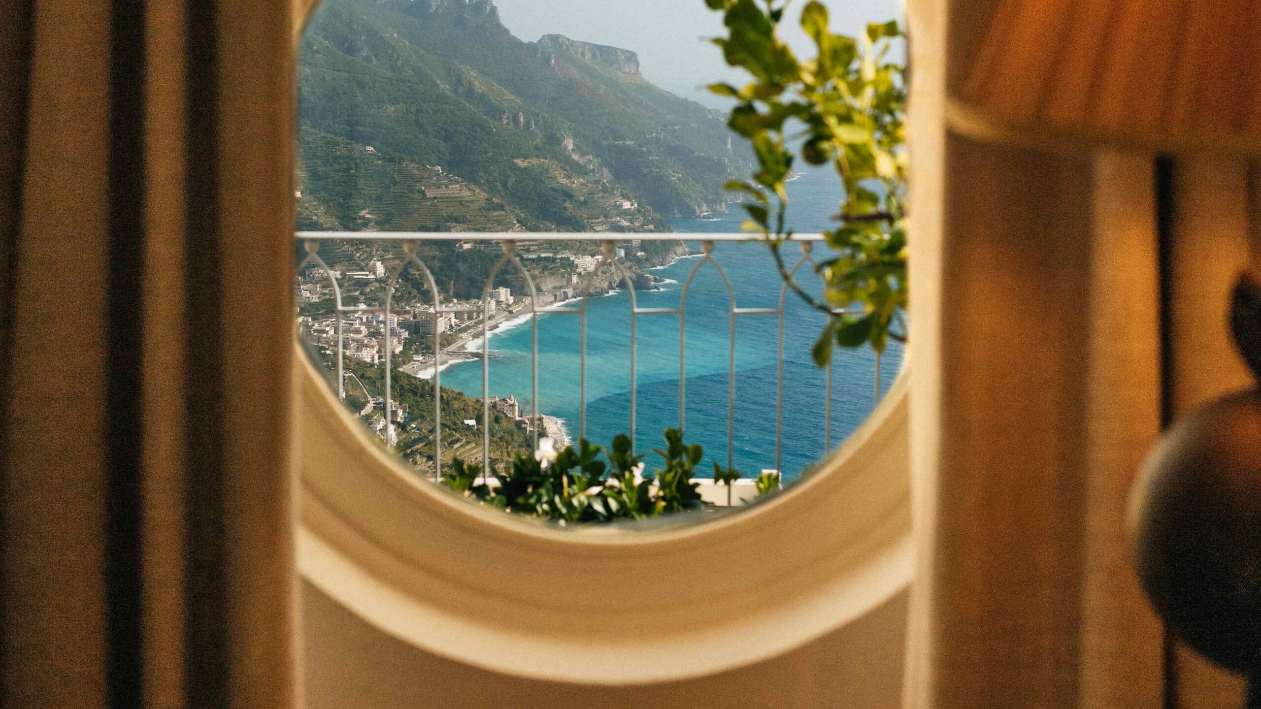 Round window view of the coast from a junior suite, Belmond Hotel Caruso