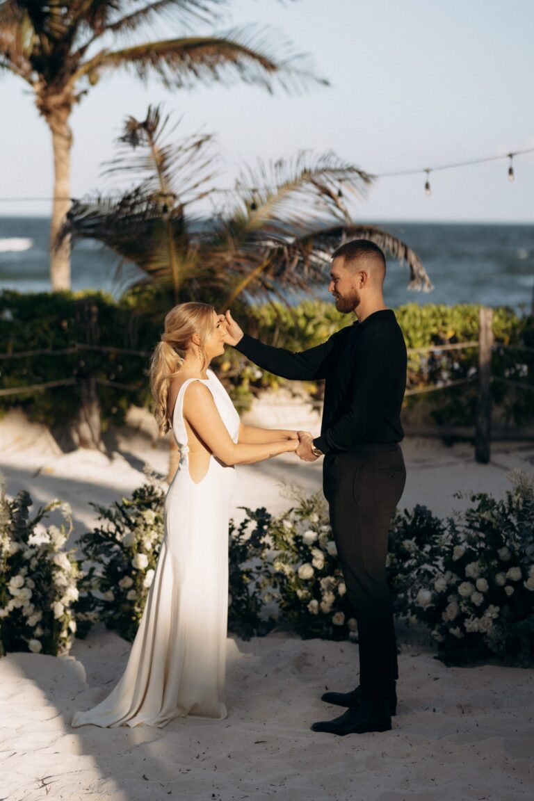 An elopement at Tulum with the couple surrounded by white florals and palms, Better Together Mexico