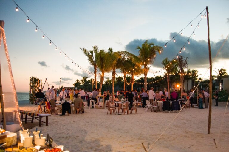 Beach reception at dusk with festoon lights and palm trees, Better Together Mexico