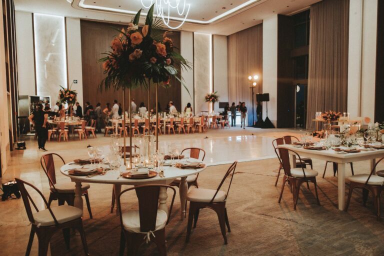 Reception in a ballroom set with round tables and tall floral centrepieces, Better Together Mexico