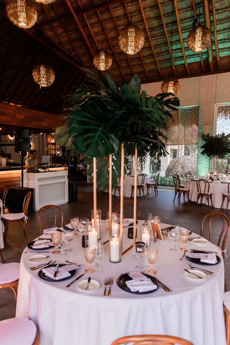 Round table with tall tapers, palms and warm lanterns in a jungle venue, Better Together Mexico