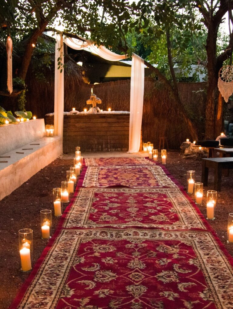 A red carpet lined with candles leading to a canopy at a Tulum venue, Better Together Mexico