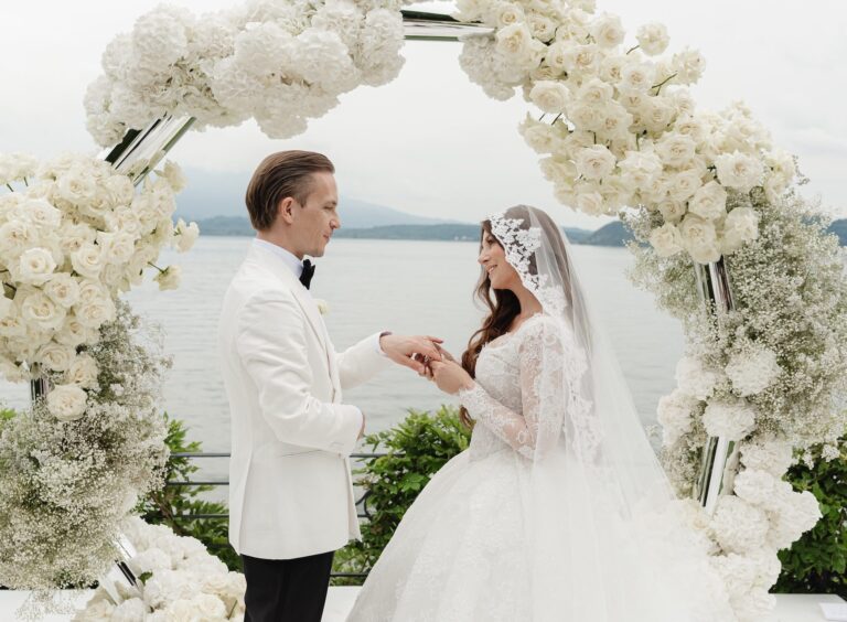 Vows inside a ring of white roses and gypsophila, the lake behind, Bianco Bouquet Weddings and Events