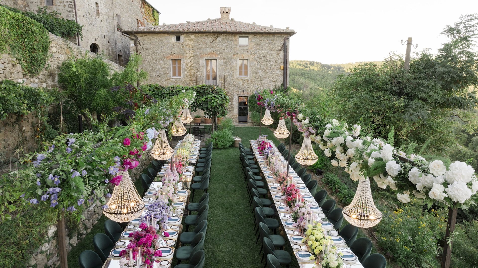 Two long tables running toward the house, pendants and flowers down both sides, Bianco Bouquet Weddings and Events