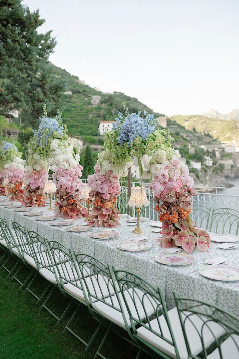A long table above the coast, tall pink and blue hydrangea arrangements, Bianco Bouquet Weddings and Events