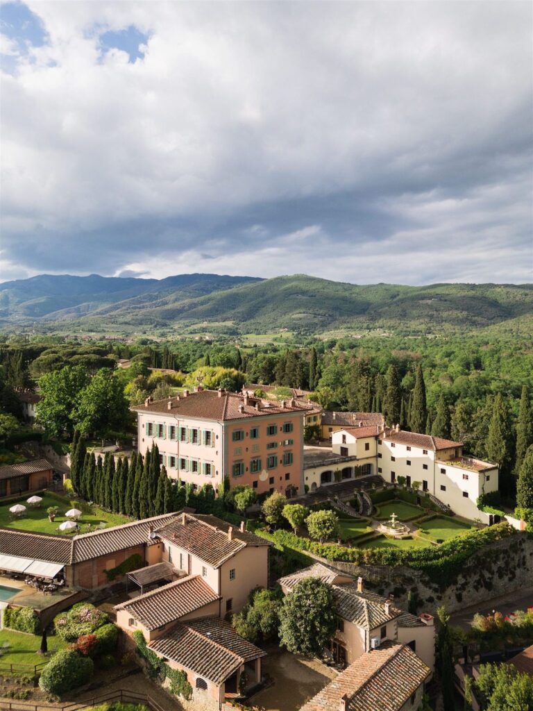 From the air: a villa in its cypresses, the roofs of the hamlet below, Bianco Bouquet Weddings and Events