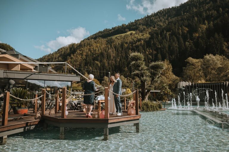 Ceremony on a lakeside deck beside fountains, Bilingual Celebrant in Europe