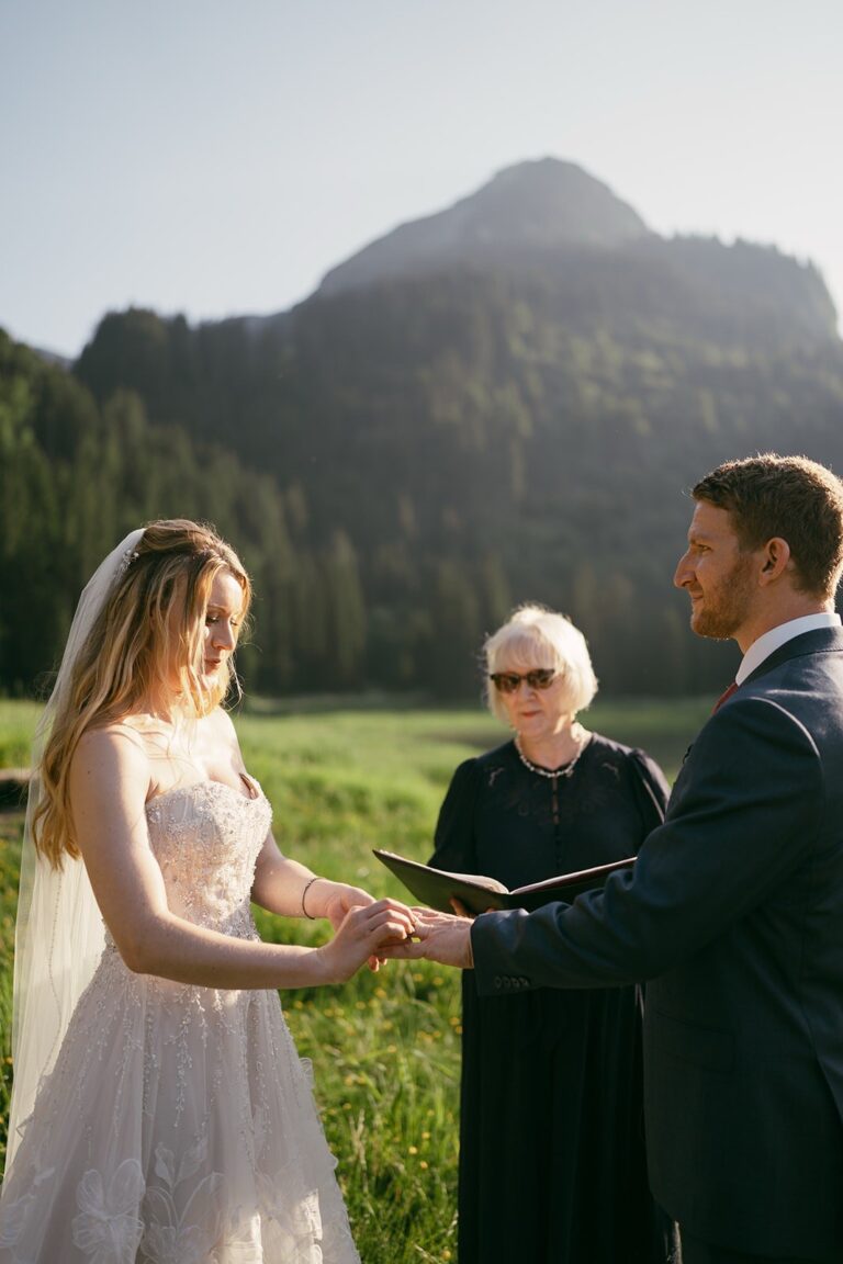 Celebrant leading a vows moment on an alpine meadow, Bilingual Celebrant in Europe