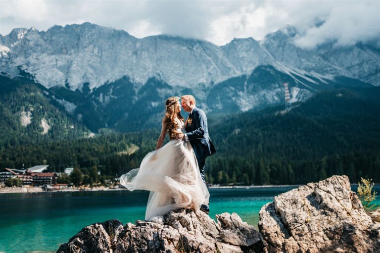 Couple on a rock above Lake Eibsee with the Zugspitze massif behind, Bilingual Celebrant in Europe