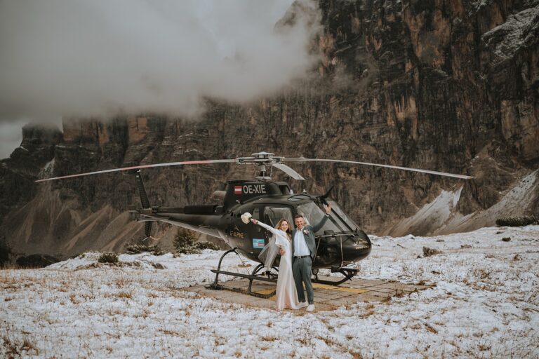 Couple beside a helicopter on a high mountain plateau, Bilingual Celebrant in Europe