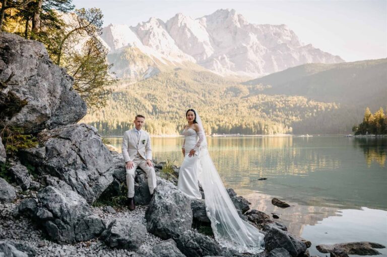 Couple seated on the rocks above an alpine lake in Bavaria, Bilingual Celebrant in Europe