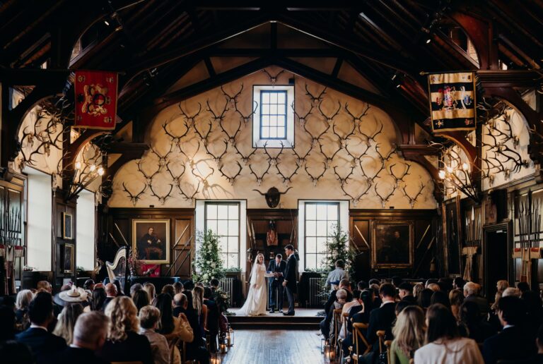 A ceremony under way at the end of the Ballroom, guests seated in rows, Blair Castle