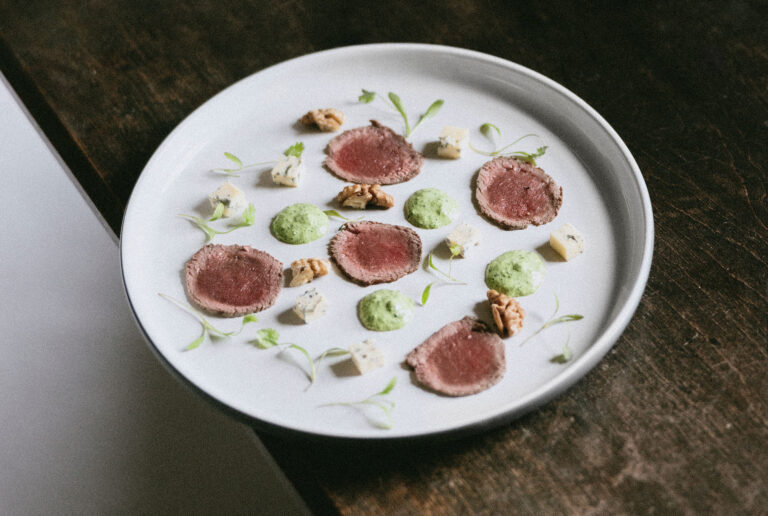 Sliced venison with green sauce on a white plate, Blair Castle