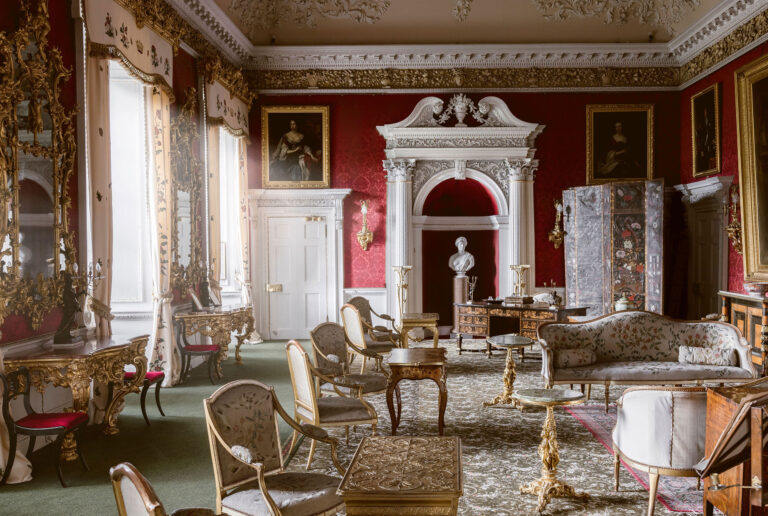 A Georgian state room with red walls, gilded furniture and a carved chimneypiece, Blair Castle