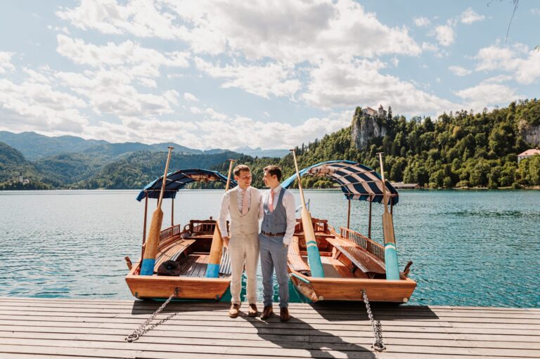 Couple on the Lake Bled jetty with traditional boats, Bled Rose Hotel