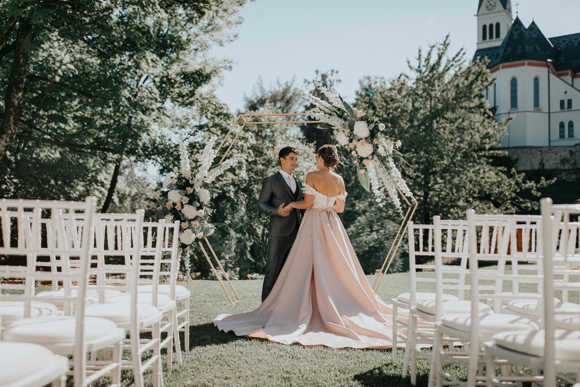 Ceremony chairs and floral arch in the garden, Bled Rose Hotel