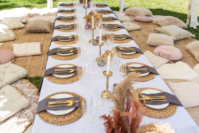 Long picnic-style table with cushions on the lawn, Bled Rose Hotel
