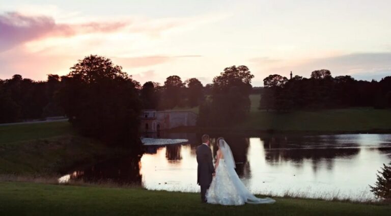The Palace mirrored in the lake at dusk, a bride at the shoreline, Blenheim Palace