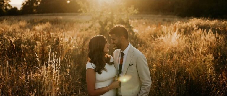 Emma and Rajiv in the long grass at golden hour at Elmore Court, Gloucestershire (frame from their film), Blue Ridge Films